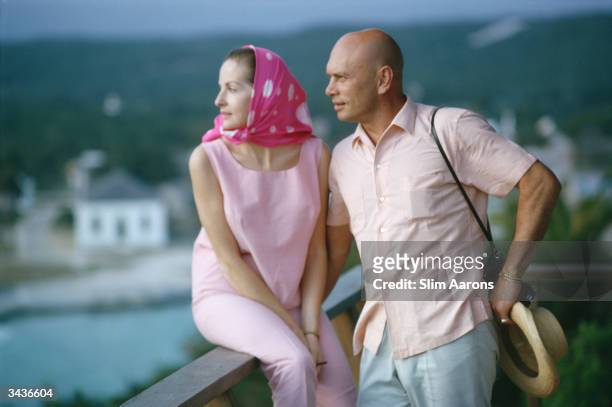 Film star Yul Brynner and his wife, Doris Kleiner, looking out over the Nassau Channel, Bahamas.