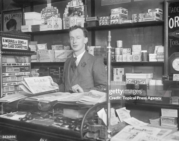 Henry Crane, a blind tobacconist trained at st Dunstan's, behind the counter in his shop.