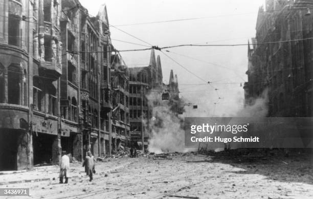 Street in Hamburg with smouldering debris and gutted buildings after a bombing raid in World War II.