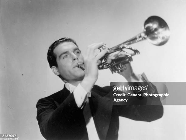 American leading man Fred MacMurray plays the trumpet in a scene from 'Swing High, Swing Low', the story of a talented trumpeter who goes on a bender...