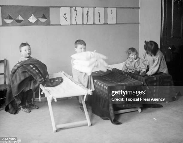 Youngsters preparing for their afternoon nap at a nursing home for the children of British soldiers during World War I.