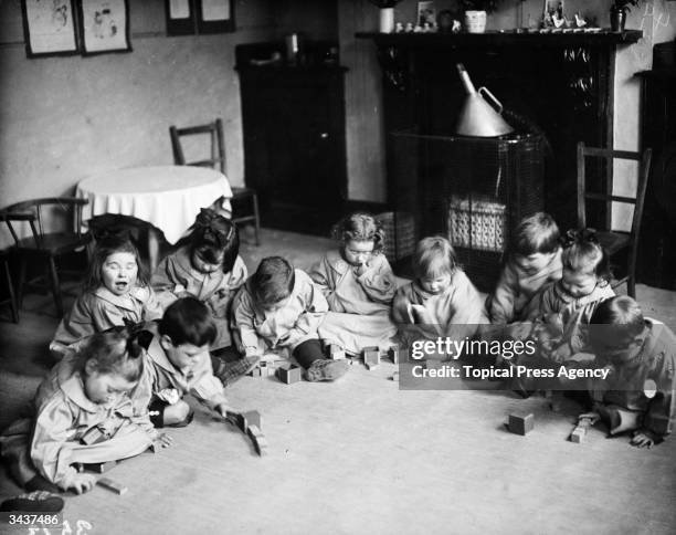 Play hour at a nursing club for 'Tommy Atkins Jnr', the children of British soldiers during World War I.