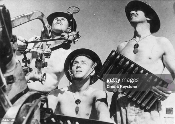 British gunners manning a captured Breda gun in the beleaguered town of Tobruk are preparing to fire at any German aircraft which may come within...