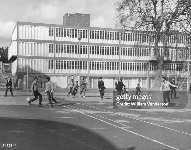 Pupils playing football in the playground of the Henry Thornton Comprehensive School in Clapham Common, south London.