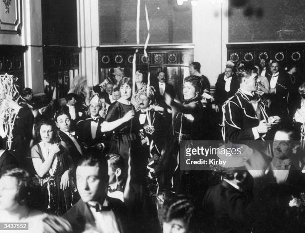 Revellers celebrate the New Year during a party at the Hotel Victoria in London.