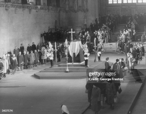 Members of the public file past the catafalque in Westminster Hall where the coffin of former prime minister Winston Churchill is lying in state,...