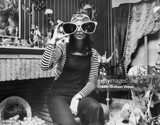 Jenny Cartwright, a shop assistant at the Biba boutique in Kensington, poses in the shop's household department.
