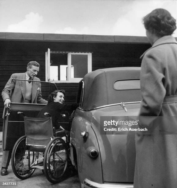 Wheelchair bound actress Pamela Russell getting in to her car at Mandeville Hospital while her husband holds the door for her. Original Publication:...