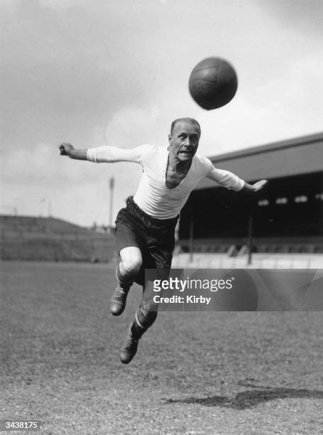 Fulham FC right-back J Houghton heads the ball during a training session.