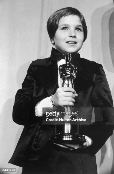American actor Tatum O'Neal, wearing a tuxedo, holds her Oscar for Best Supporting Actress for her role in director Peter Bogdanovich's film, 'Paper...
