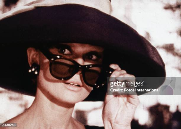 Belgian-born actor Audrey Hepburn lowers her sunglasses in a still from director Blake Edwards' film, 'Breakfast at Tiffany's.'
