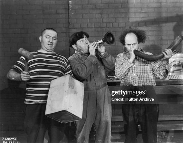 The Three Stooges turn plumbing equipment into musical instruments in a still from an unidentified film. L-R: Curly Howard , Moe Howard and Larry...