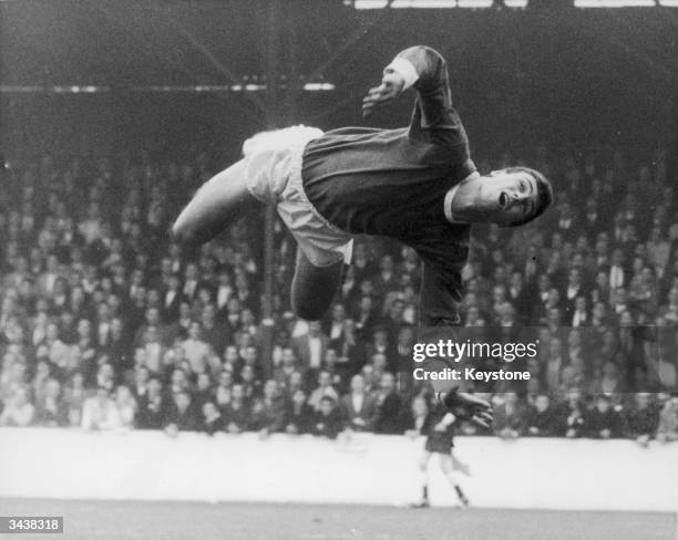 Birmingham goalkeeper Colin Withers leaps into action during a match against West Ham. His efforts were unnecessary, as the ball went over the...
