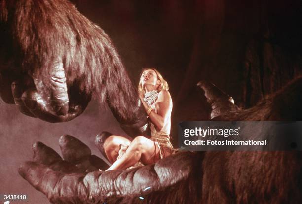 American actor Jessica Lange sits in the hand of a giant gorilla in a still from the film, 'King Kong,' directed by John Guillermin.