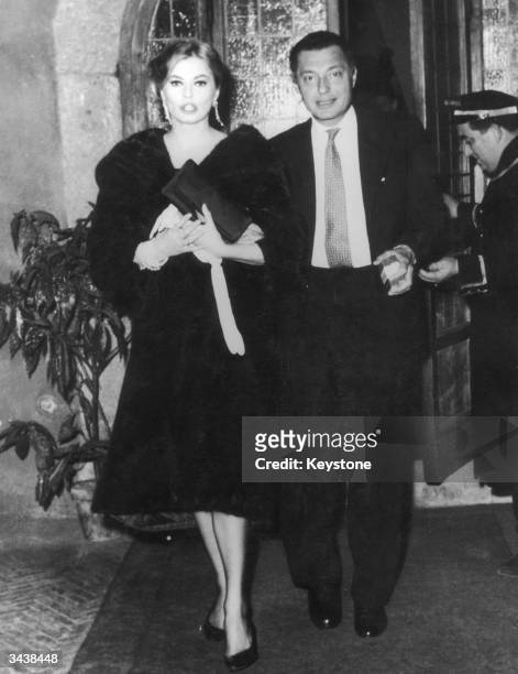 Fiat tycoon Gianni Agnelli leaves the Hostaria dell'Orso in Rome with Swedish film star Anita Ekberg, in the early hours of the morning.