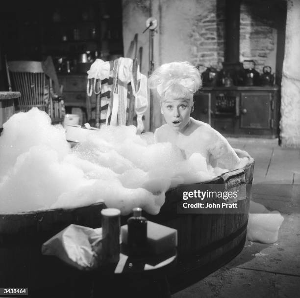 Barbara Windsor in a bubble bath during filming of 'Crooks in the Cloisters'.