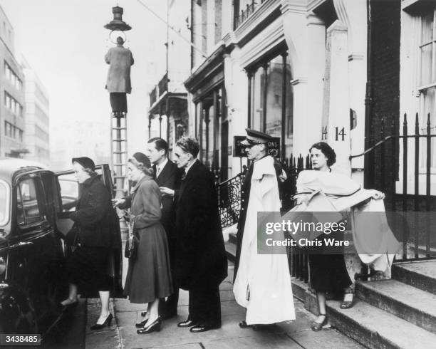 Royal couturier Hardy Amies and his team leave Savile Row in London for Clarence House, to deliver the clothes he has made for Princess Elizabeth's...