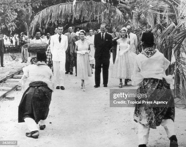 Queen Elizabeth II and the Duke of Edinburgh are presented with a Welcome Dance as they arrive at the Cocos Islands for a short visit. They are with...