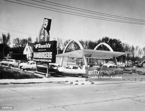 Exterior of a McDonald's drive-in fast food restaurant, which advertises 15-cent hamburgers, Chicago, Illinois.