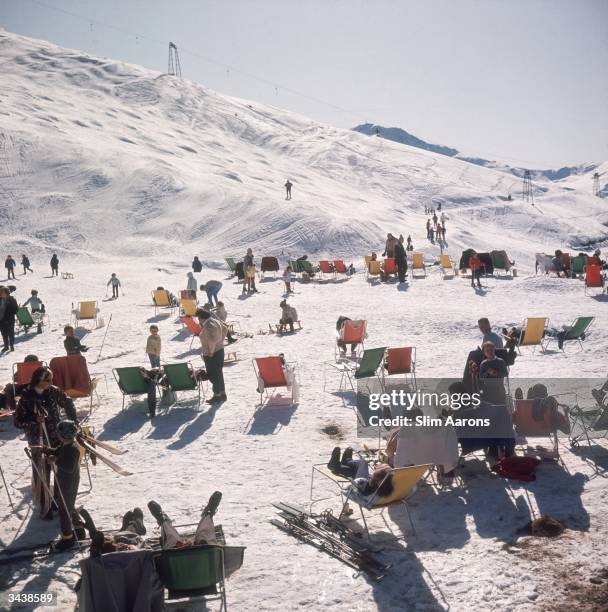Skiers relax in deckchairs on the slopes at Verbier in Switzerland.