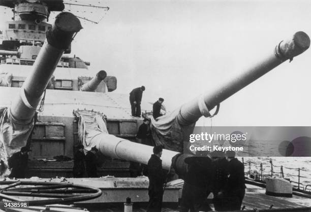 The large calibre guns of the German battleship Scharnhorst being prepared for use. She was sunk by the British navy off Norway in December 1943, in...