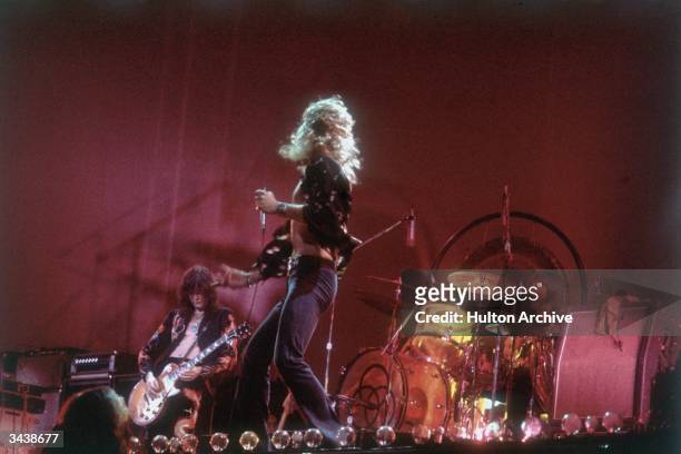 Rock group Led Zeppelin performing on stage. From left to right: Jimmy Page, Robert Plant and John Bonham .