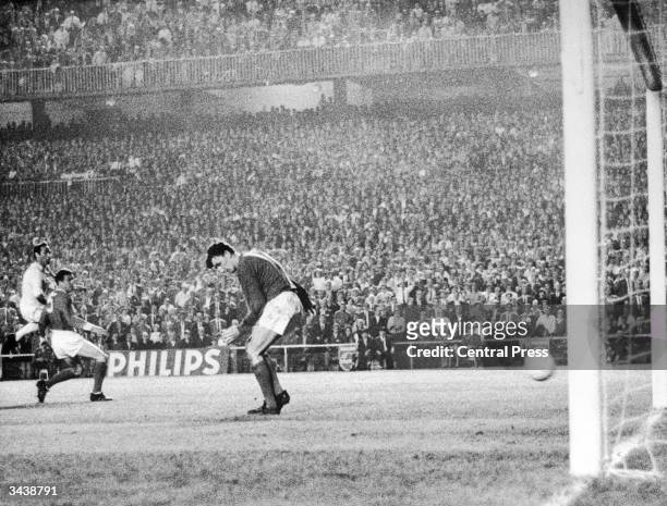 Manchester United keeper Alex Stepney lets the ball go through his legs for Francisco Gento to score Real Madrid's second goal in the European Cup...