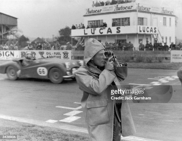 English racing driver Stirling Moss films his sister Pat competing in the Ladies' Invitation Race at Goodwood. Pat Moss won the race, the first...