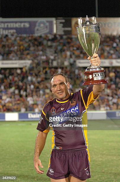 Gorden Tallis of the Broncos holds the XXXX Cup aloft after the NRL match between the North Queensland Cowboys and the Brisbane Broncos at Dairy...
