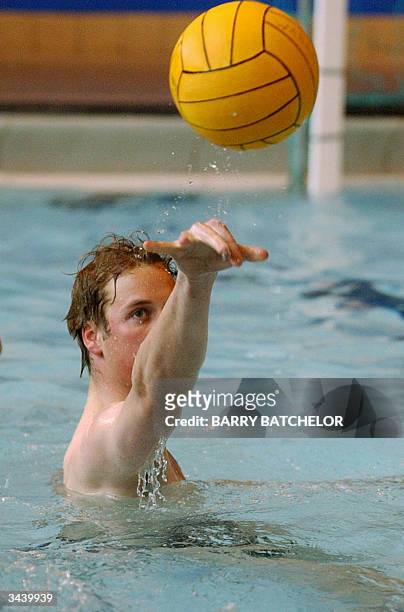 Prince William tosses the ball during his water polo debut for the Scottish national universities squad in the annual Celtic Nations tournament...