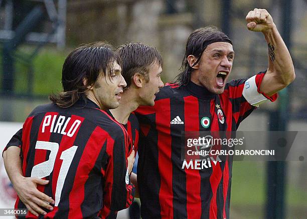 Milan's captain Paolo Maldini jubilates with his teammates Andrea Pirlo and Ukrainian striker Andryi Shevchenko after the first goal against Siena,...