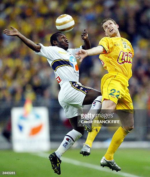 Sochaux' Nigerian midfielder Wilson Oruma fights for the ball with Nantes' defender Sylvain Armand during their French League Cup final at the Stade...