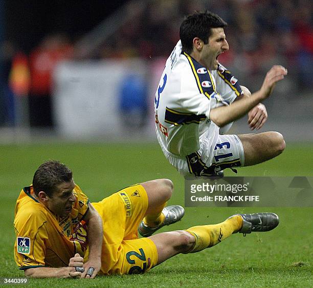 Sochaux' striker Pierre-Alain Frau is tackled by Nantes' defender Sylvain Armand during their French League Cup final at the Stade de France in...
