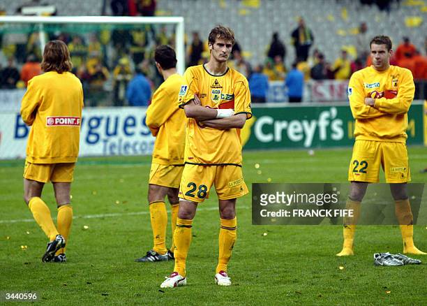 Nantes' striker Gregory Pujol and defender Sylvain Armand react after losing against Sochaux the French League Cup final at the Stade de France in...
