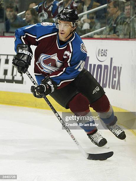 Joe Sakic of the Colorado Avalanche takes the puck around the net against the Dallas Stars in game five of the first round of the Stanley Cup...