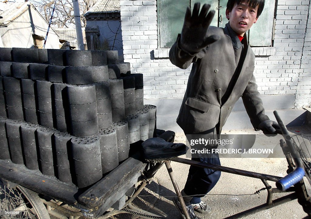 A man gestures while delivering bricks o