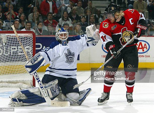 Ed Belfour of the Toronto Maple Leafs makes a save on a tip by Daniel Alfredsson of the Ottawa Senators during game six of the Eastern Conference...