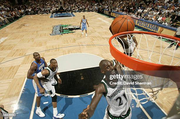 Kevin Garnett of the Minnesota Timberwolves grabs the rebound against the Denver Nuggets in game one of round one of the 2004 NBA Western Conference...