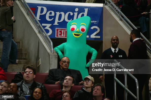 Person wears a costume of the television character Gumby while watching the game from the stands between the New York Knicks and the Philadelphia...
