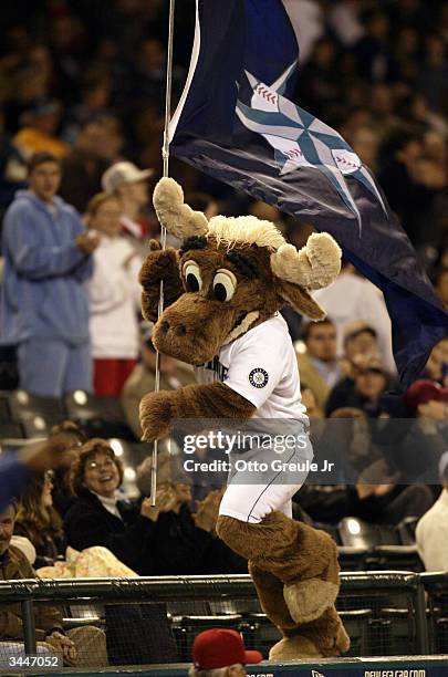 The Moose, mascot of the Seattle Mariners, runs atop the dugout with a Mariners flag during the MLB game against the Anaheim Angels on April 7, 2004...