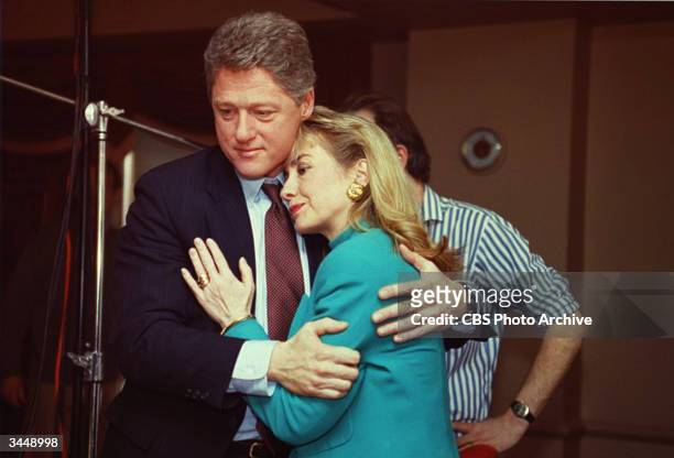 Arkansas Governor Bill Clinton comforts Hillary Rodham Clinton on the set of the news program '60 Minutes' after a stage light unexpectedly broke...