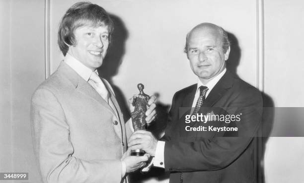 British Television comedy writer Jimmy Perry recieves the Ivor Novello Award for best TV Signature tune from Ian Abrahams, 5th July 1971. Perry's...