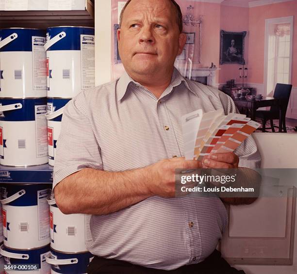 man with samples in store - chubby man shopping stock pictures, royalty-free photos & images