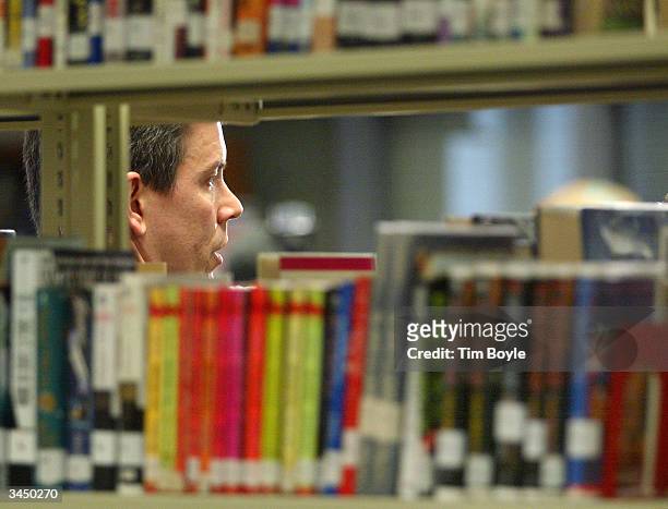 Chicago Public Schools CEO Arne Duncan, framed by a book shelf, addresses the news media in the library at Jones College Prep High School April 20,...