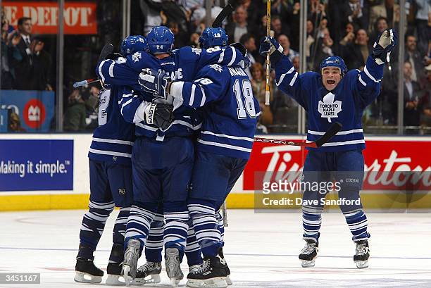Tie Domi of the Toronto Maple Leafs joins his teammates in celebration of Bryan McCabe's goal against the Ottawa Senators during game seven of the...