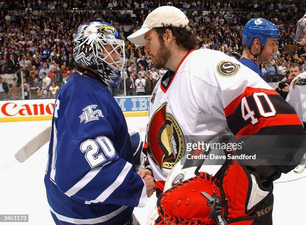 Ed Belfour of the Toronto Maple Leafs shakes hands with Patrick Lalime of the Ottawa Senators during the traditional series ending handshake after...