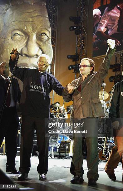 Nelson Mandela and Bono of U2 perform at The Nelson Mandela Foundation's "46664 Give One minute to Aids" Concert at The Greenpoint Stadium on...