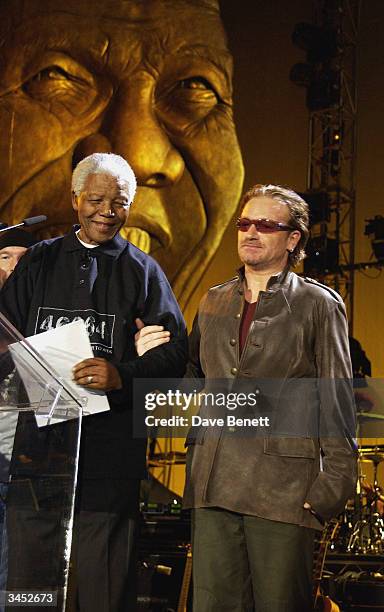 Nelson Mandela and Bono of U2 perform at The Nelson Mandela Foundation's "46664 Give One minute to Aids" Concert at The Greenpoint Stadium on...