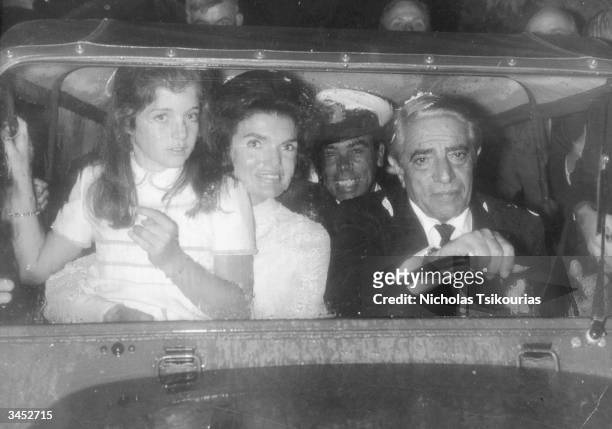 Greek shipping magnate Aristotle Onassis in a car with his new wife Jacqueline Onassis and her daughter Caroline, circa 1968.
