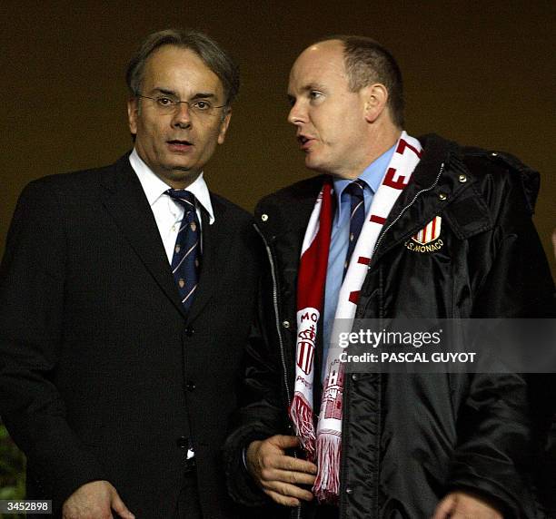 Prince Albert of Monaco and Monaco's president Pierre Svara talk as they attend the Champions League semi-final first-leg football match between...